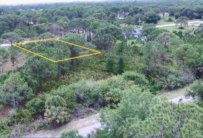 Drone view from above the bike trail, approaching the lot