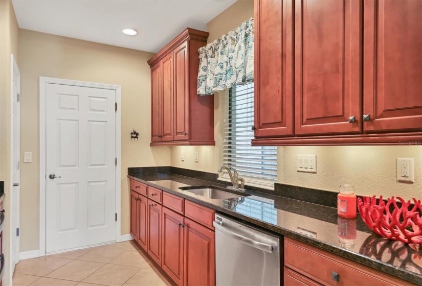 Beautiful all wood cabinetry with granite countertops and stainless steel appliances