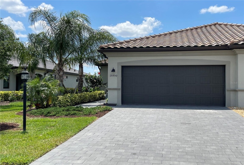 Front entrance, 2 car garage and pavered driveway