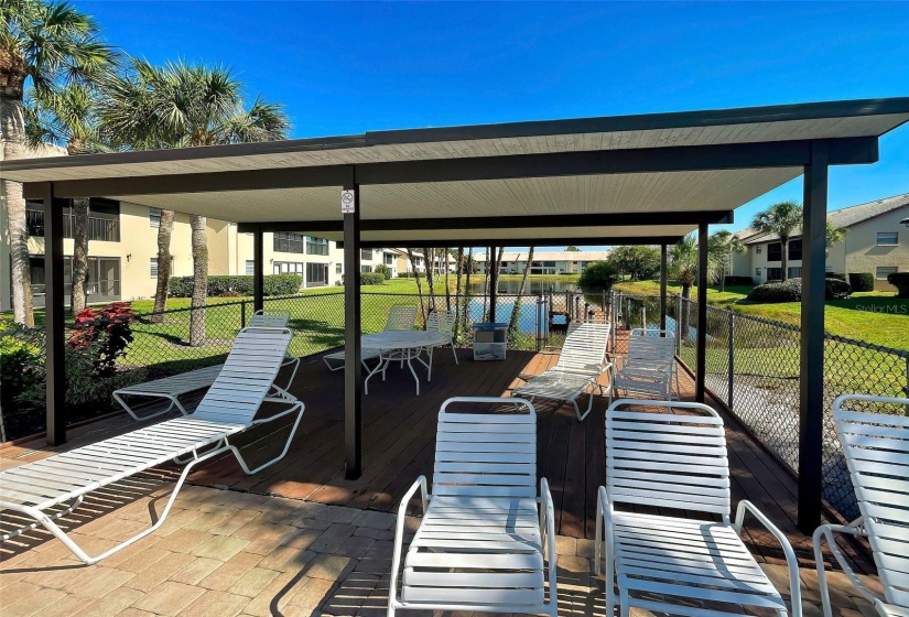 SHADED DECK AT THE POOL.   GREAT PLACE TO MEET UP WITH YOUR FRIENDS AND NEIGHBORS