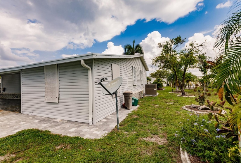 Back yard. Satellite dish, New air conditioner, trees and landscaping, back of shed