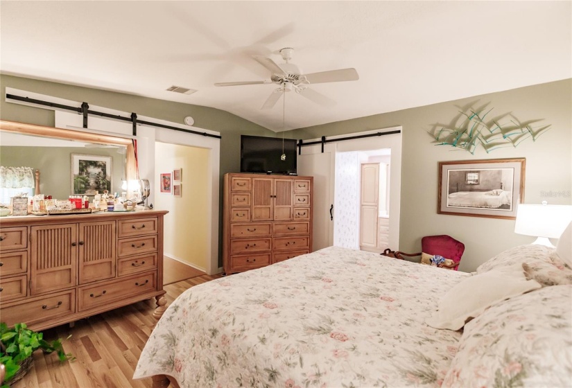 Amazing Master suite with two closets, one that is the length of the room and deep. The other is a large walking closet just off the Master bath.  Amazing beautiful hung barn doors add class to the decore.