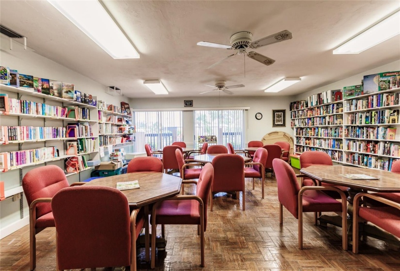 Library with five game table and chairs. Serious games are played here.  Check out the Club house hallway event center bulletin boards with major activities and games.