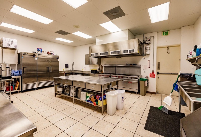 Banquet Hall's Industrial Kitchen with large refrigerators, stove, oven and serving window. Ready for Dinner? Check your calendar or  Check out the Club house hallway event center bulletin boards with major activities and games.