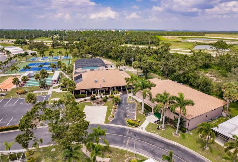 Aerial of the Community. Burnt Store Colony Resident Owned, 55+ gated community is highly sought after, with only 236 manufactured beautiful homes located on Burnt Store Road, in Punta Gorda, Florida. In 2022 the Southwest Gulf Coast Community Association Institute voted Burnt Store Colony one of the top three South West Gulf Coast communities in which to live. Major activities, Heated, screened pool and spa. Club house has smaller, multi functional building, Kitchen, Dining area, Pool tables, ping pong tables, storage area, library with games tables and chairs, fitness center, hallway event center bulletin board. New Banquet Hall with industrial kitchen, ceiling projector with computer display on large screen. Large smart TV/VCR with internet. Used for morning coffee, dinners, dances, bingo and major social activities, restrooms and more.ds with major activities, access to the huge screened, heated pool and spa, restrooms and much more.