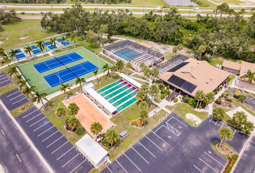 Aerial of the Community. Burnt Store Colony Resident Owned, 55+ gated community is highly sought after, with only 236 manufactured beautiful homes located on Burnt Store Road, in Punta Gorda, Florida. In 2022 the Southwest Gulf Coast Community Association Institute voted Burnt Store Colony one of the top three South West Gulf Coast communities in which to live. Major activities, Heated, screened pool and spa. Club house has smaller, multi functional building, Kitchen, Dining area, Pool tables, ping pong tables, storage area, library with games tables and chairs, fitness center, hallway event center bulletin board. New Banquet Hall with industrial kitchen, ceiling projector with computer display on large screen. Large smart TV/VCR with internet. Used for morning coffee, dinners, dances, bingo and major social activities, restrooms and more.ds with major activities, access to the huge screened, heated pool and spa, restrooms and much more.