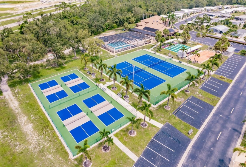 Aerial of the Community. Burnt Store Colony Resident Owned, 55+ gated community is highly sought after, with only 236 manufactured beautiful homes located on Burnt Store Road, in Punta Gorda, Florida. In 2022 the Southwest Gulf Coast Community Association Institute voted Burnt Store Colony one of the top three South West Gulf Coast communities in which to live. Major activities, Heated, screened pool and spa. Club house has smaller, multi functional building, Kitchen, Dining area, Pool tables, ping pong tables, storage area, library with games tables and chairs, fitness center, hallway event center bulletin board. New Banquet Hall with industrial kitchen, ceiling projector with computer display on large screen. Large smart TV/VCR with internet. Used for morning coffee, dinners, dances, bingo and major social activities, restrooms and more.ds with major activities, access to the huge screened, heated pool and spa, restrooms and much more.