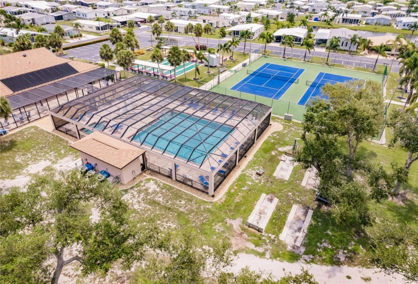 Aerial of the Community. Burnt Store Colony Resident Owned, 55+ gated community is highly sought after, with only 236 manufactured beautiful homes located on Burnt Store Road, in Punta Gorda, Florida. In 2022 the Southwest Gulf Coast Community Association Institute voted Burnt Store Colony one of the top three South West Gulf Coast communities in which to live. Major activities, Heated, screened pool and spa. Club house has smaller, multi functional building, Kitchen, Dining area, Pool tables, ping pong tables, storage area, library with games tables and chairs, fitness center, hallway event center bulletin board. New Banquet Hall with industrial kitchen, ceiling projector with computer display on large screen. Large smart TV/VCR with internet. Used for morning coffee, dinners, dances, bingo and major social activities, restrooms and more.ds with major activities, access to the huge screened, heated pool and spa, restrooms and much more.