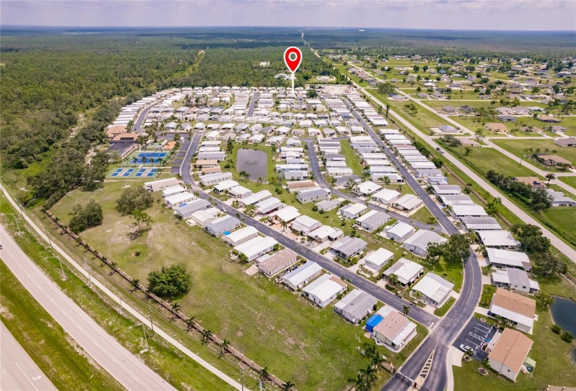 Aerial of the Community. Burnt Store Colony Resident Owned, 55+ gated community is highly sought after, with only 236 manufactured beautiful homes located on Burnt Store Road, in Punta Gorda, Florida. In 2022 the Southwest Gulf Coast Community Association Institute voted Burnt Store Colony one of the top three South West Gulf Coast communities in which to live. Major activities, Heated, screened pool and spa. Club house has smaller, multi functional building, Kitchen, Dining area, Pool tables, ping pong tables, storage area, library with games tables and chairs, fitness center, hallway event center bulletin board. New Banquet Hall with industrial kitchen, ceiling projector with computer display on large screen. Large smart TV/VCR with internet. Used for morning coffee, dinners, dances, bingo and major social activities, restrooms and more.ds with major activities, access to the huge screened, heated pool and spa, restrooms and much more.