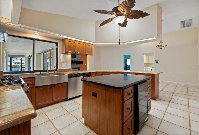 Kitchen is light, bright and open to the Family Room, with adjacent dining area to the right of photo. Doorway to laundry room.