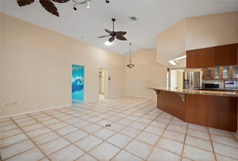 Family Room looking toward kitchen and dinette area. Bedroom 4 (blue) doorway and laundry room doors to left of photo.