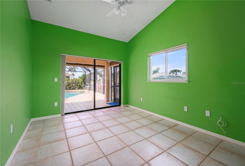 Bedroom 2, with glass doors to pool/lanai