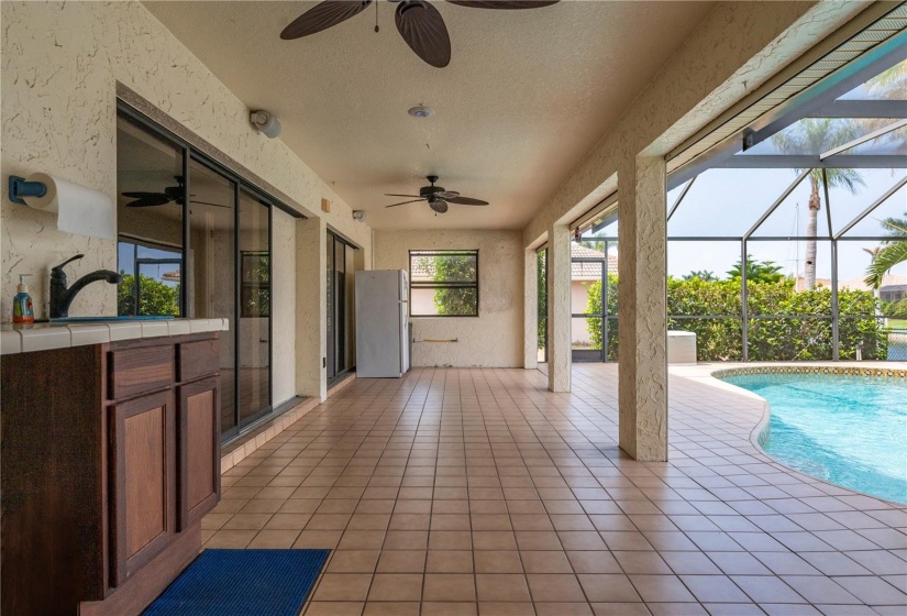 Covered area of lanai with sink, counter and gas hook-up for barbeque grill & refrigerator