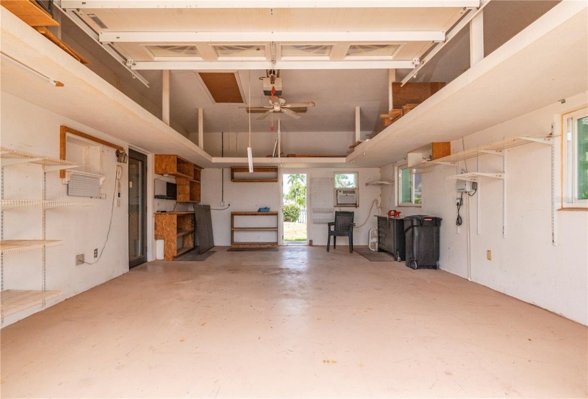 WORKSHOP in 3rd bay of garage, with man door to rear yard and through the wall AC unit