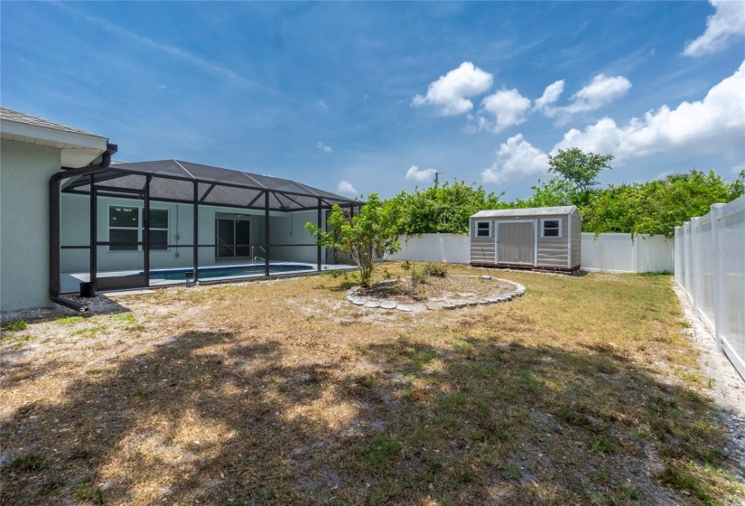 Rear exterior with fenced backyard