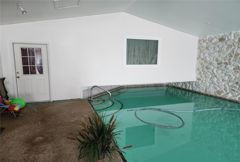 Raised bedroom over shallow end of indoor pool