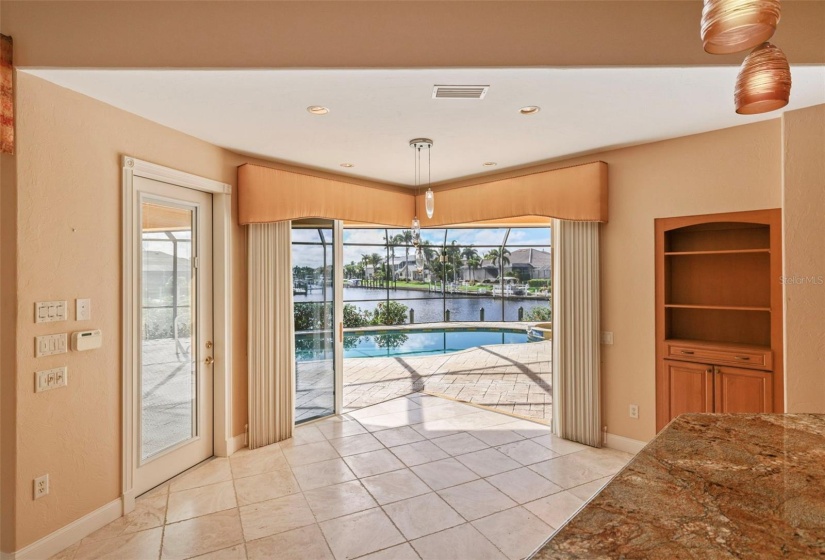 Breakfast nook open to pool area and displaying a gorgeous view