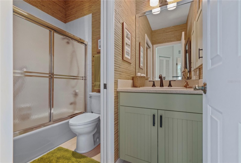 Third Bathroom, tall vanity, handwoven, hand painted bamboo wall covering, pocket door divides sink from toilet/tub area