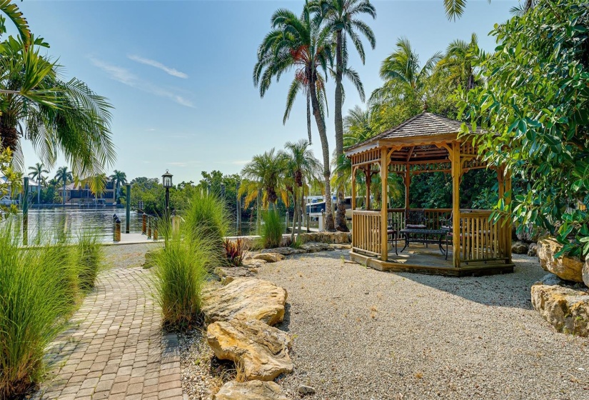 Paver brick pathway to dock and 4 boat slips, with view of gazebo