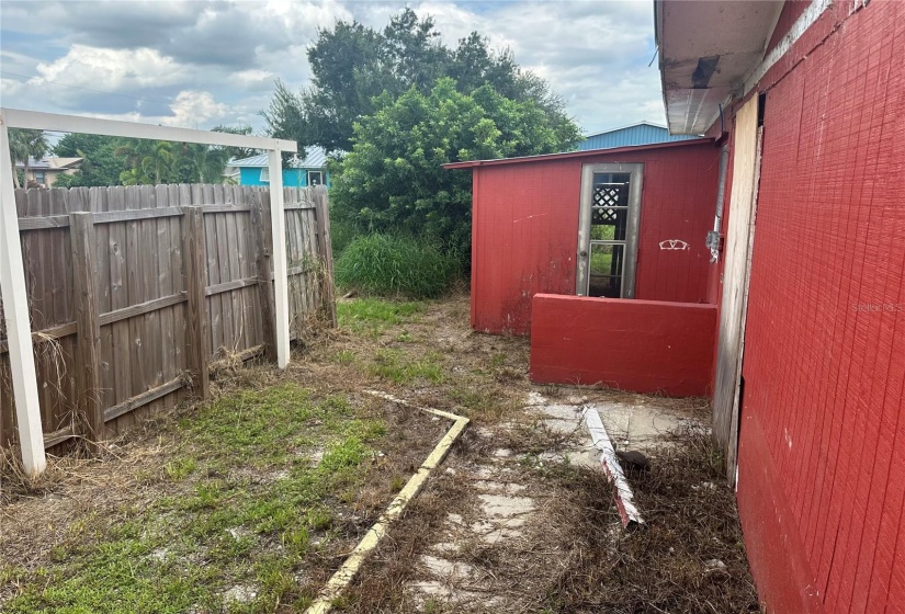 Fenced area on left side and attached shed.