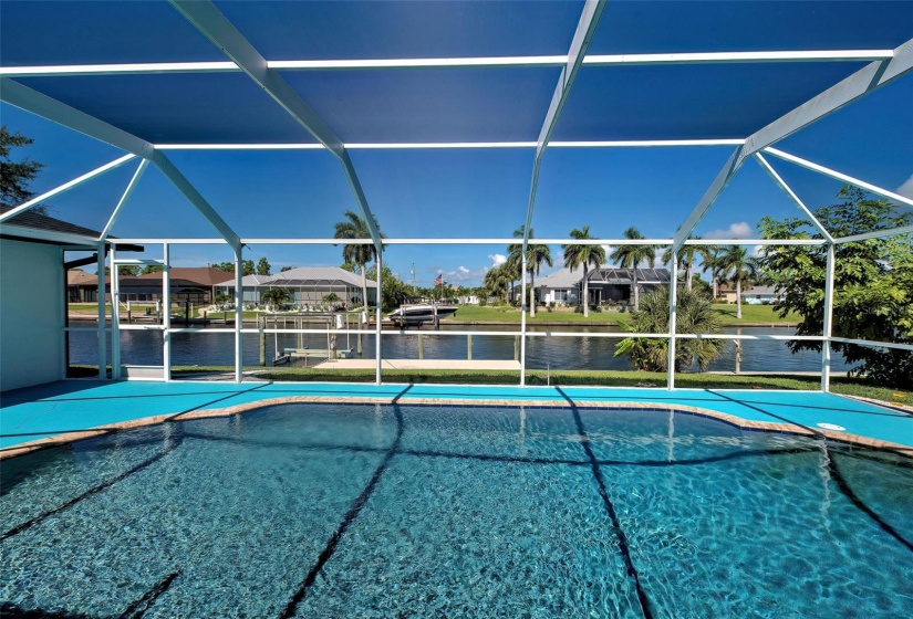 Pool view, Canal with concrete dock and boat lift.