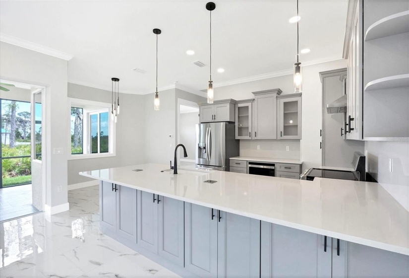 Kitchen is spacious and provides extra cabinet storage along front of island