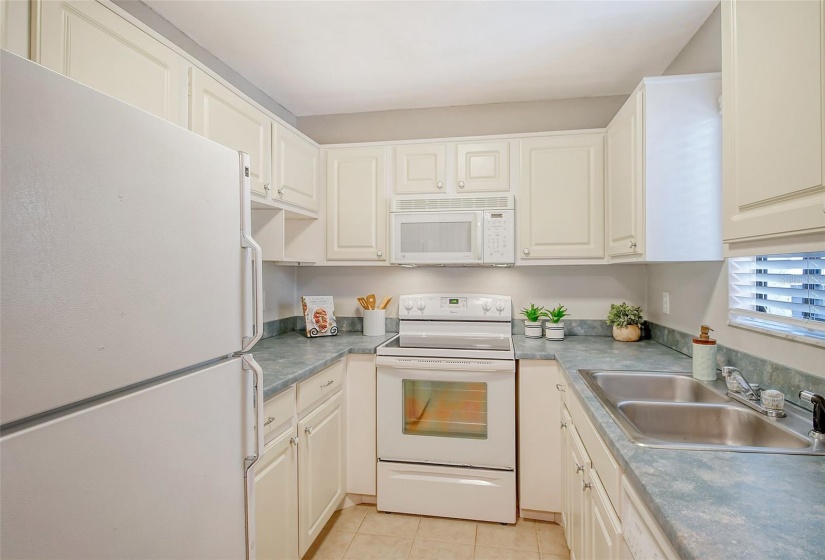 Kitchen features a sunny window over the sink.