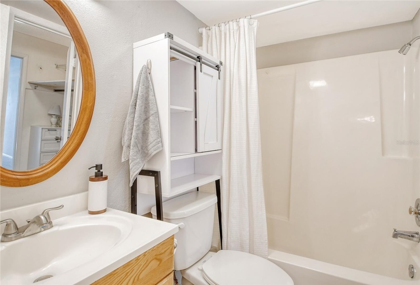 Bathroom with single vanity and shower/tub combination.