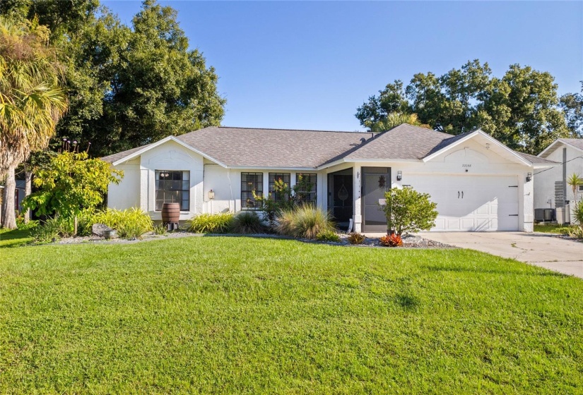 FRONT VIEW WITH LUSH LANDSCAPING