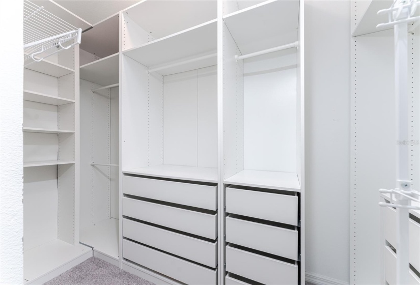 Master bedroom's walk-in closet with customized shelving system.