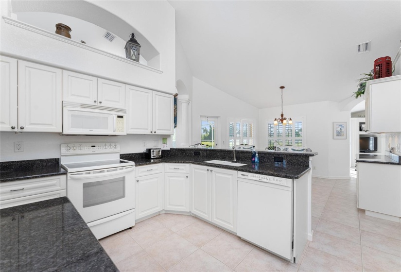 Kitchen has plenty of cabinetry and counterspace  with granite counter tops!