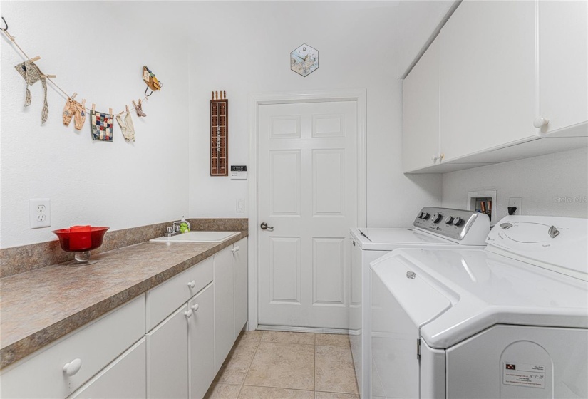 Laundry room has lots of upper and lower cabinetry!