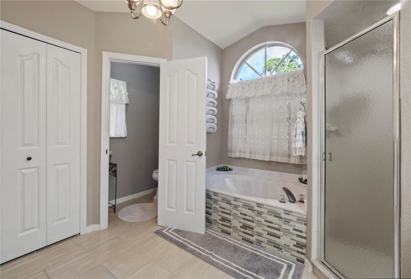 Ensuite bathroom with both tub and shower and a private water closet