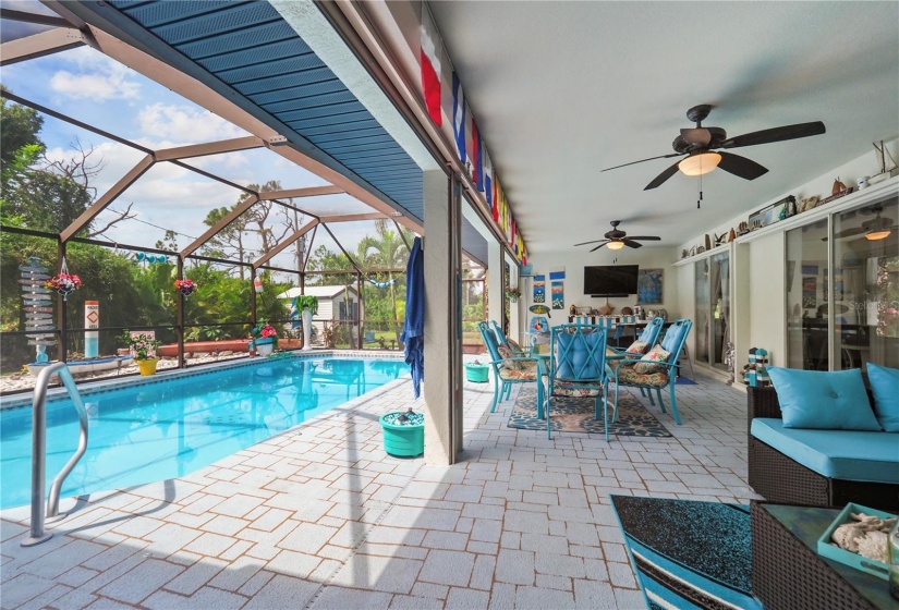 Picture of the huge covered lanai and pool.  Lots of space for entertaining. Note the roll down hurricane shutters.