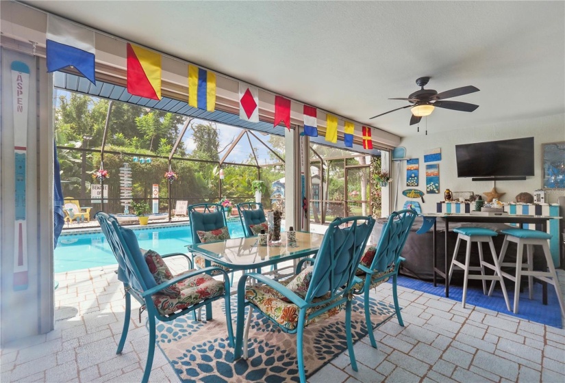 Covered lanai area with ceiling fans, lights and hookups for wall mounted television.