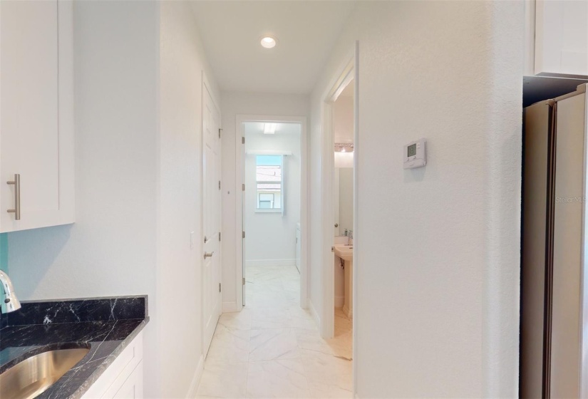 View from Butlers kitchen down hallway to 1/2 bath & laundry