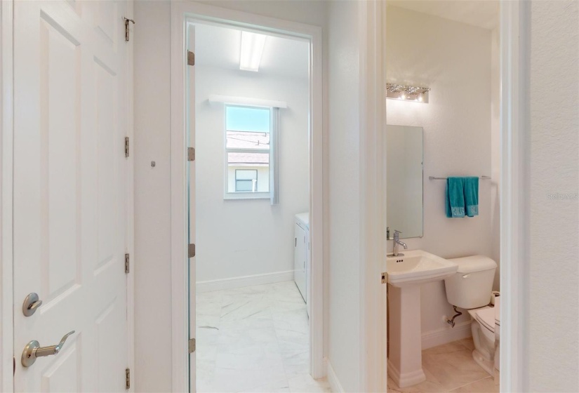 View into 1/2 bath and laundry room