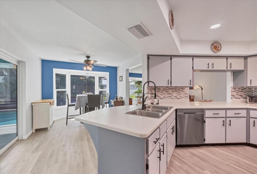 Kitchen has island and breakfast nook