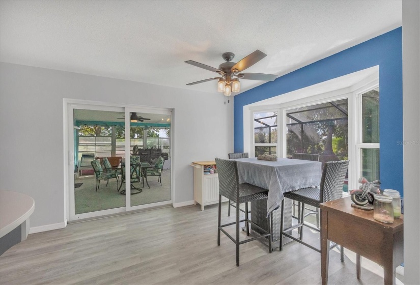 Breakfast nook with impact windows and sliders to pool