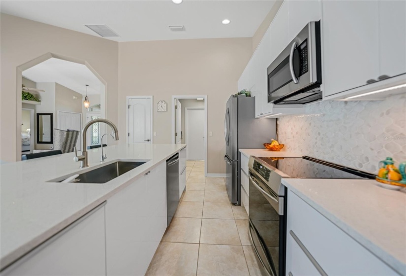 To left is the front door and dining area. Closed door is pantry. Open door is laundry room the to garage.