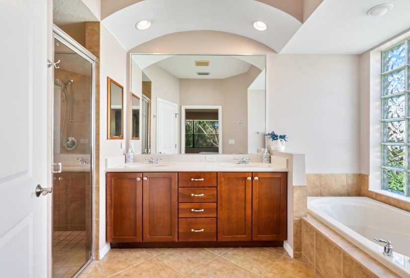 Owners ensuite bathroom featuring dual sinks, a walk-in shower, garden tub and private water closet.