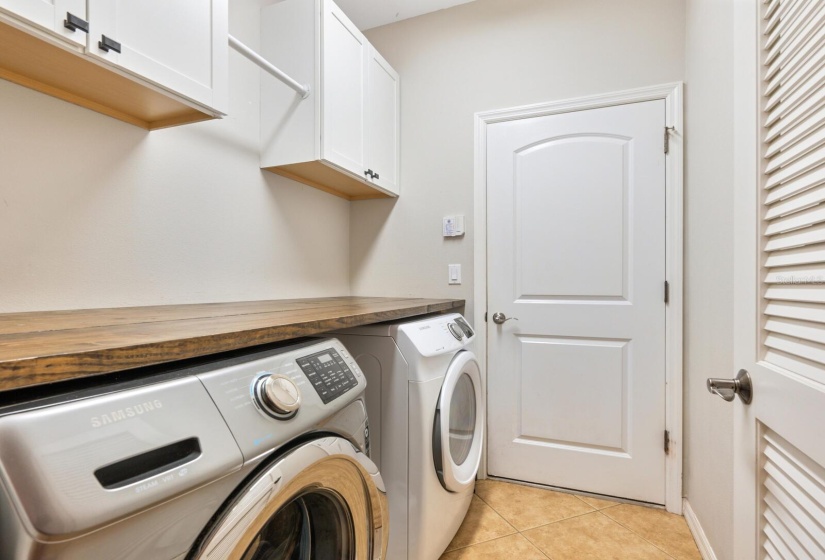 Laundry room featuring cabinetry for ample storage.