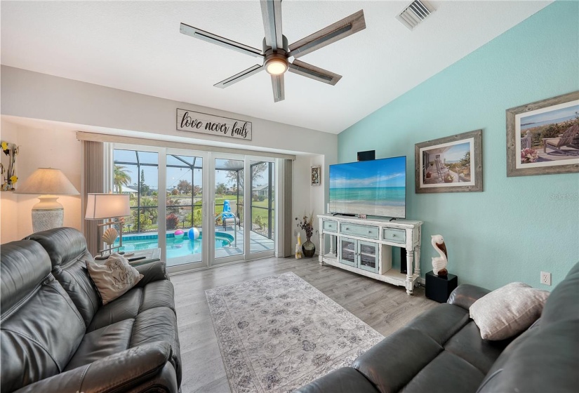 Hurricane coded sliding glass doors open to pool area.