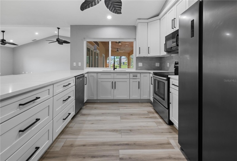 Chef's dream all wrapped up in this kitchen! Solid stone granite counters, white shaker cabinets with black hardware, double door closet pantry and stainless appliances