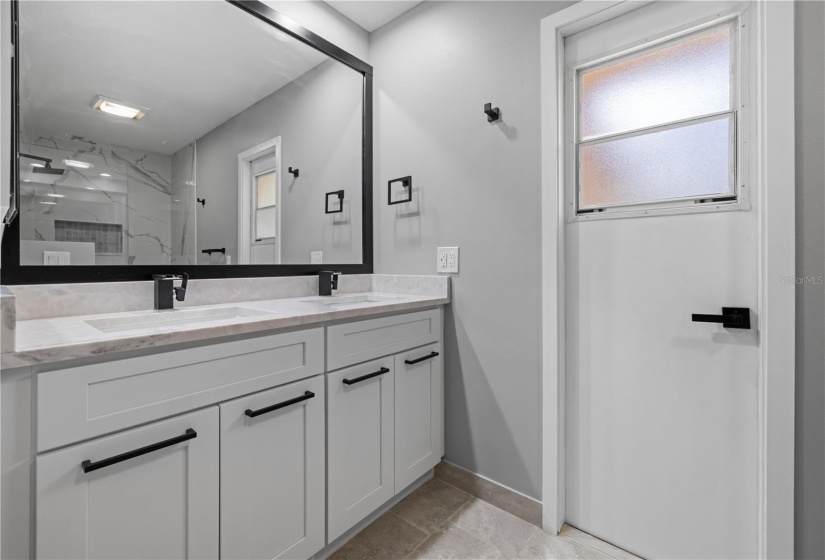 Full guest bath doubles as a pool bath, completely updated and stunning design