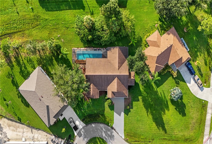 Aerial view of your new pool home is situated on an oversized lot on the cul-de-sac