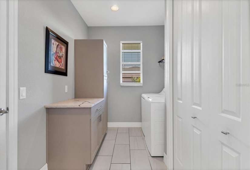 Indoor Laundry Conveniently Located Off the Garage with Built in Cabinets