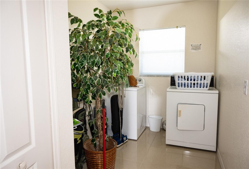 Spacious laundry room with an extra closet.