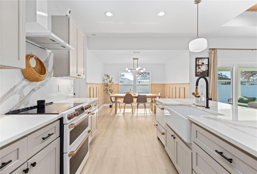 Quartz Countertop and backsplash.  Apron undermount sink.