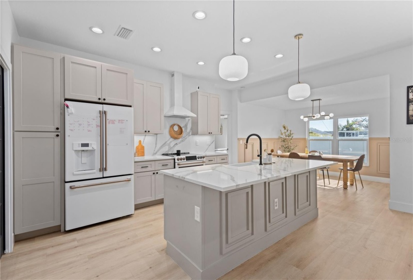 Matte White French Door Fridge, Quartz Countertop and backsplash.